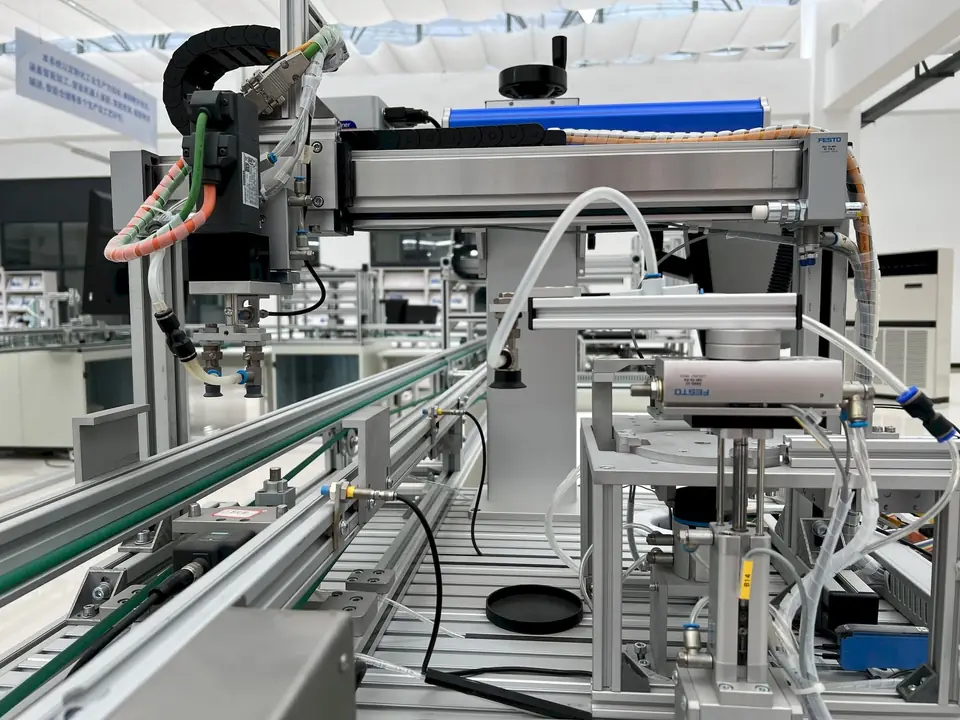 Automated assembly line with pneumatic actuators and a conveyor