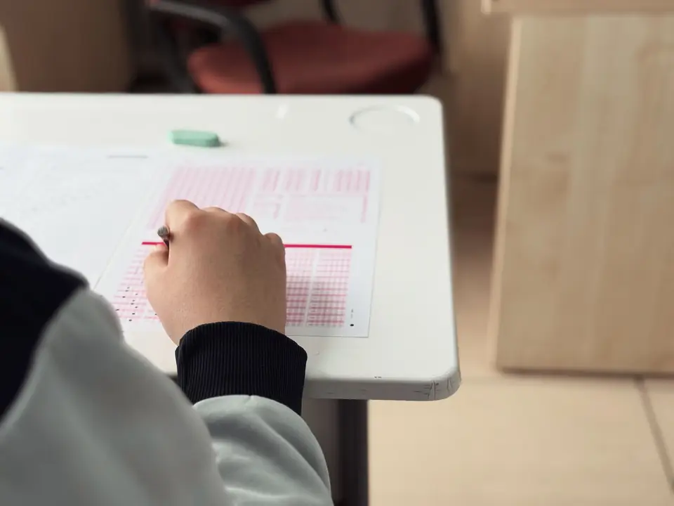 Student marking an answer sheet during an examination