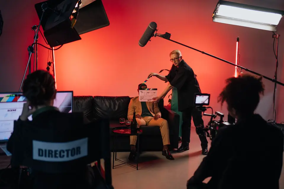 Film crew shooting a scene on a studio set lit in red