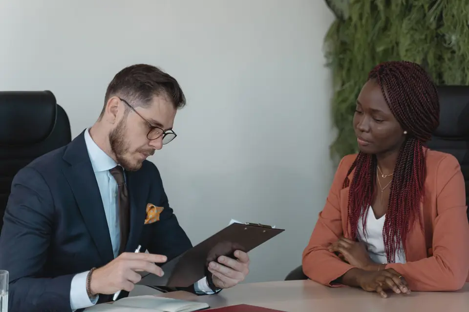 Interviewer reviewing a candidate profile on a clipboard
