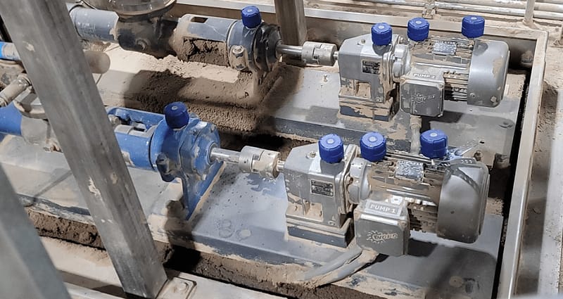Industrial pump and motor sets on a plant floor