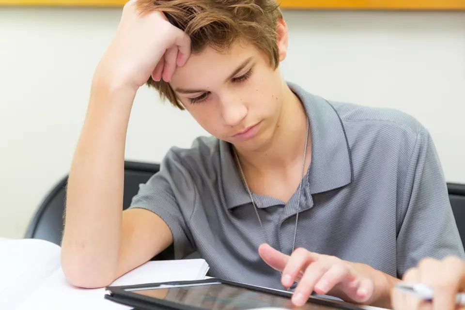 Student working on a tablet in class